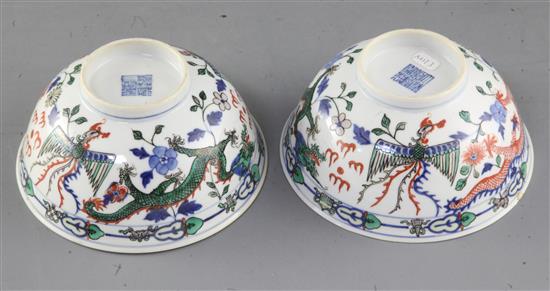 A pair of Chinese doucai dragon bowls, late 19th/early 20th century, diameter 15cm, one with small reglued chip to rim